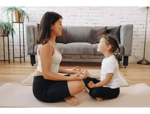 mom and daughter meditating